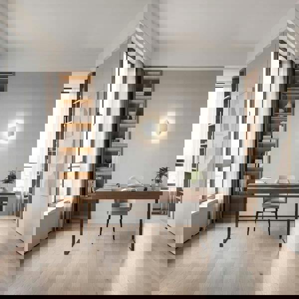 White indoor decorative wall light above a desk in the study of a modern home