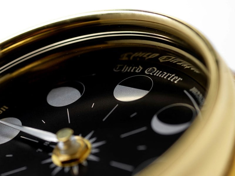 Prestige Brass Moon Phase Clock With a Jet Black Dial Mounted on a Solid English Dark Oak Wall Mount - TABIC CLOCKS