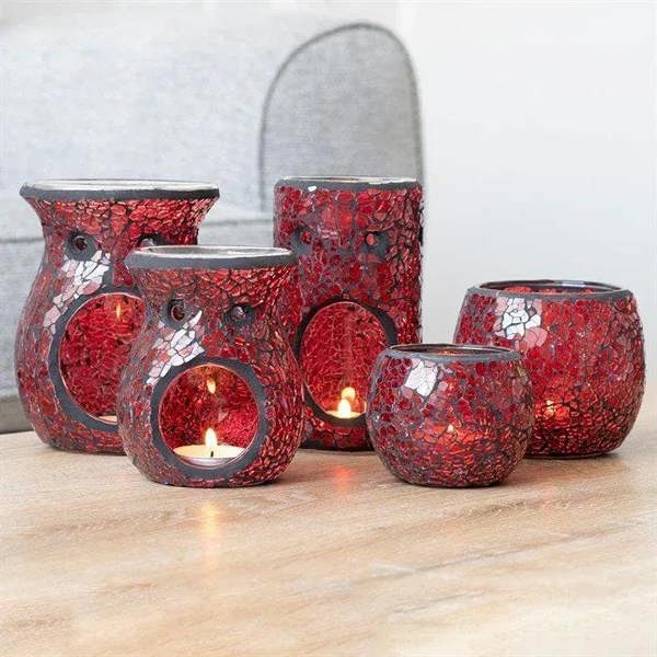 Set of red crackle glass wax warmers with circular candle openings and flames