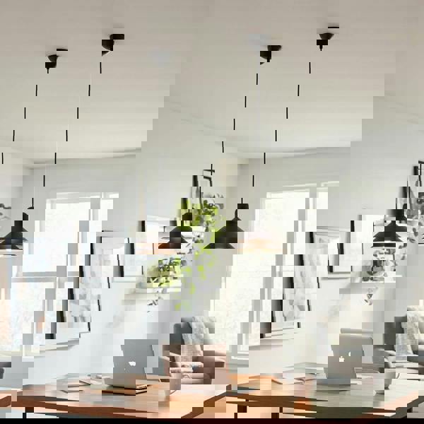 Modern black pendant light above a desk in a study in a modern homme