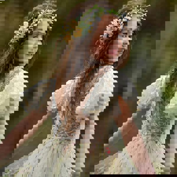 girl smiling looking behind at camera
