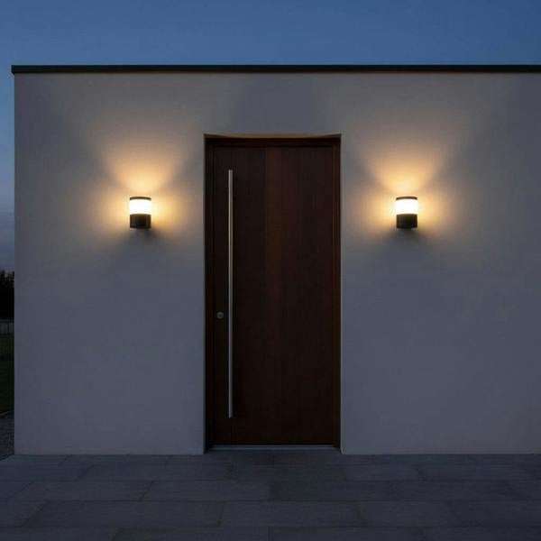 black outside wall lantern mounted either side of a wooden front entrance door 