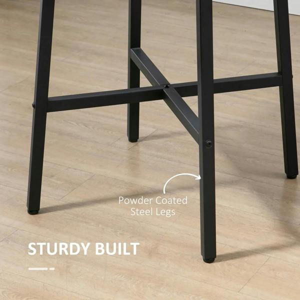 Close-up of black steel legs and cross brace under round rustic brown tabletop