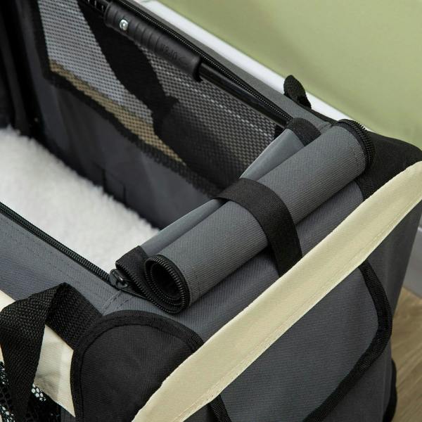 Close-up detail of grey foldable pet carrier, showing strap and rolled edge cushion.