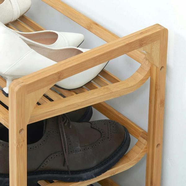 Side view of bamboo 3-tier shoe rack with slatted shelves and brown shoes