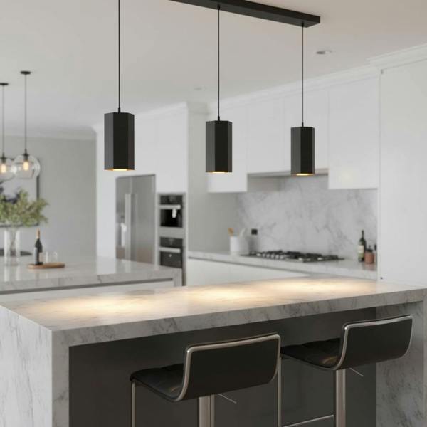 Black pendant light fitting above a breakfast bar in a modern home
