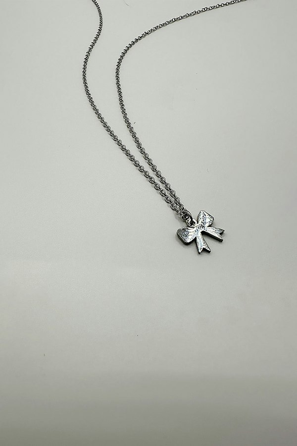 SVNX Mini Bow Pendant Necklace in Silver