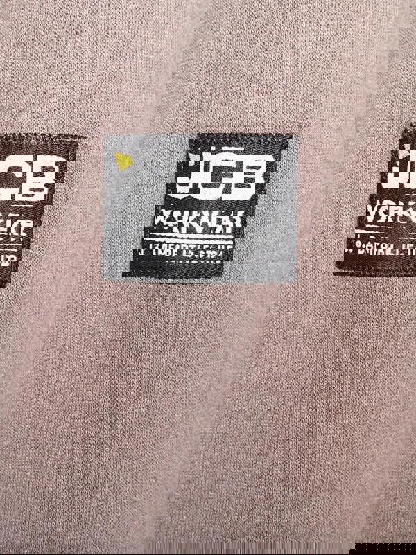 JCB Zip Thru Mens Trade Work Sweat Shirt Full Zip Hoodie, close-up of the black and white embroidered logo patch on the fabric.