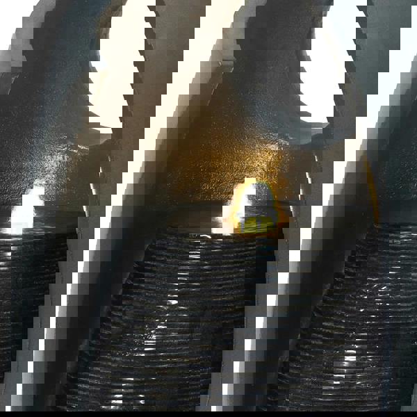 Sleek electric water feature with a modern design, featuring cascading water over textured black stone and a warm glowing light