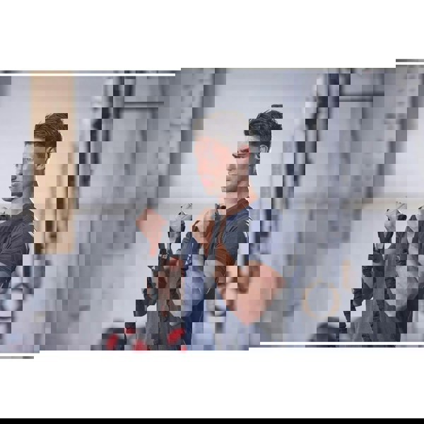 Man exercising with adidas resistance bands in a gym setting