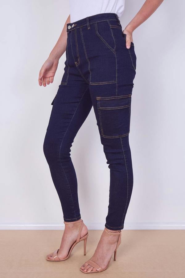 Person wearing dark blue jeans with a white background