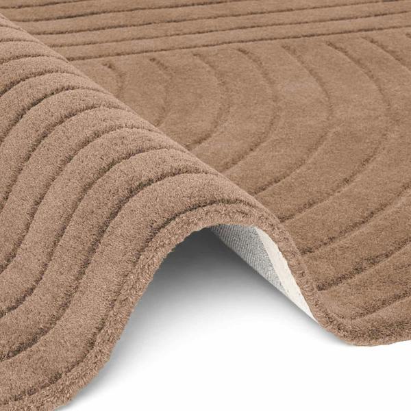 Close-up of a textured brown rug with a white border