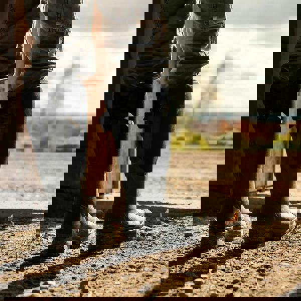 Muck Boots MUCK Chore XF Adjustable Womens Classic Stable Farm Wellington Wellies, black waterproof riding boots on a rugged outdoor ground, suitable for farm work and stable chores.