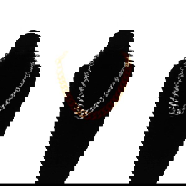 Gold chain necklace on a black mannequin bust against a white background