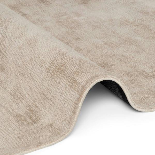 Close-up of a beige rug with a textured surface on a white background