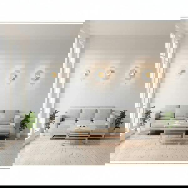 White interior LED wall light with pull cord three lights mounted on a pale coloured wall in a lounge area