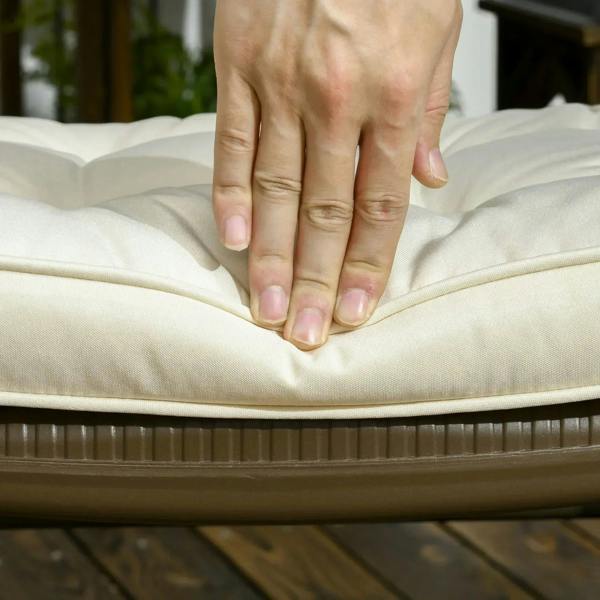 Hand pressing a cream tufted seat cushion pad for softness