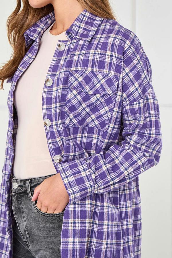Person wearing a purple plaid shirt over a white top and gray jeans.