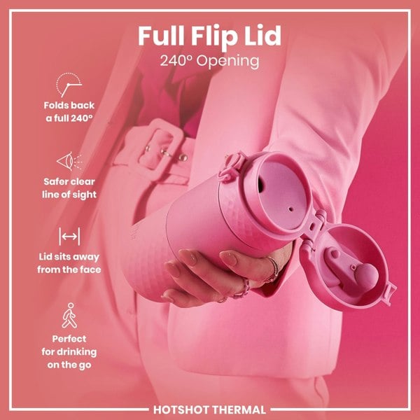 A pink thermos is being held; its lid is open 240 degrees, showcasing a full flip lid design. The context is a pink background and a person's hand in a pink jacket. Full Flip Lid, 240° Opening. HOTSHOT THERMAL.