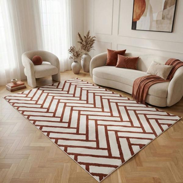 Living room with a patterned rug, sofa, and armchair.