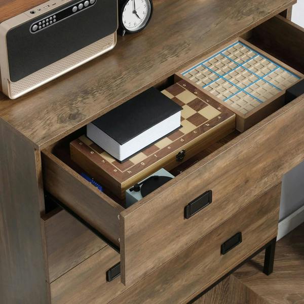 Brown chest of drawers with open drawer showing notebooks and black handles
