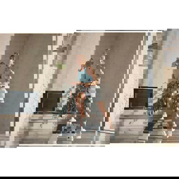 Woman performing a Reebok Deck Resistance Tube Workout - White