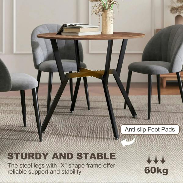 Round brown dining table with black steel legs and stable base on rug