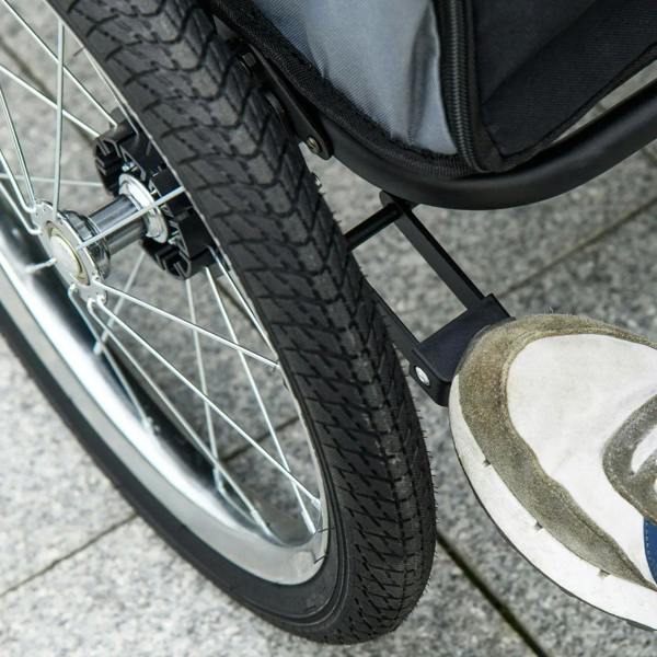 Pet stroller wheel detail with treaded tire, metal frame, and sturdy axle mount