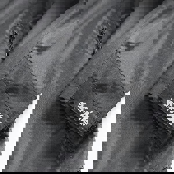 Scruffs Tech Mens Zip Up Work Warm Hooded Jacket Coat, close-up of the dark grey jacket showing the zippered pocket and the Scruffs logo on the sleeve.