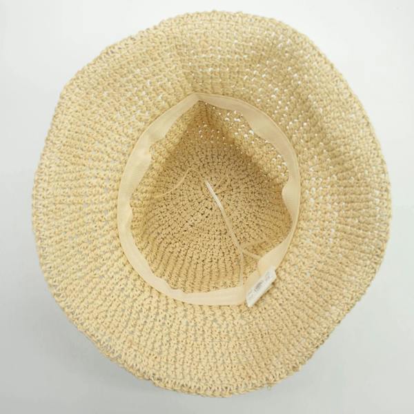 Natural beige straw floppy hat underside view with inner mesh band and ties