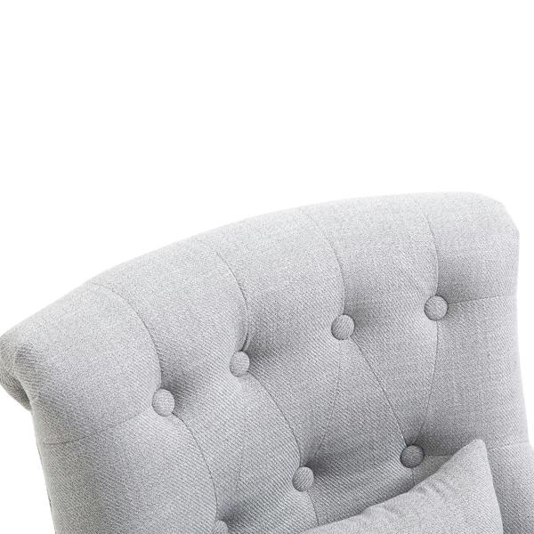 Grey tufted upholstered back and pillow on a single accent chair