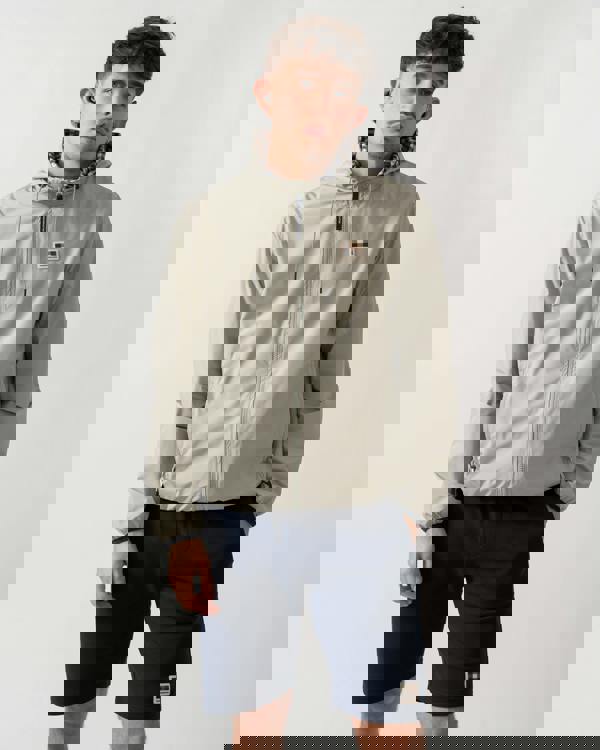 studio shot of a model wearing an Aquascutum Mens RLG Badge Reversible Sailor Jacket in Salvia 34