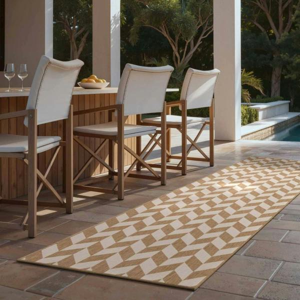 Outdoor dining area with wooden chairs and a patterned rug on a patio.