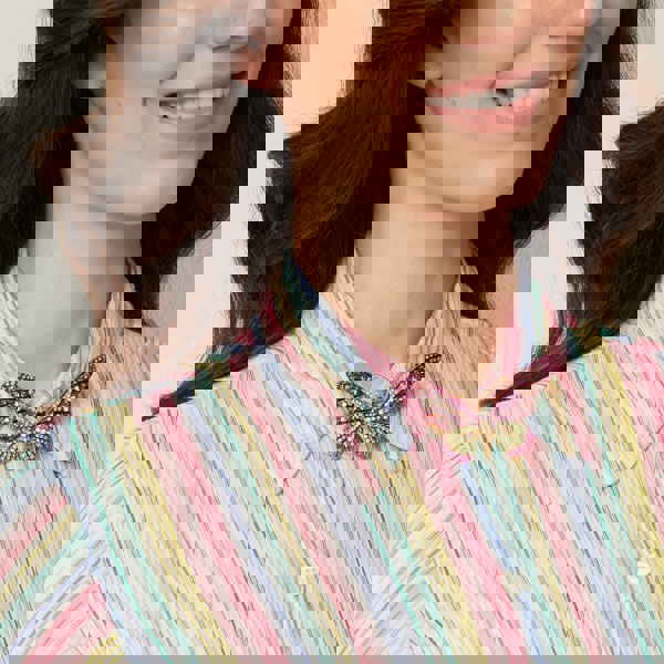 large butterfly brooch in pink worn on shirt