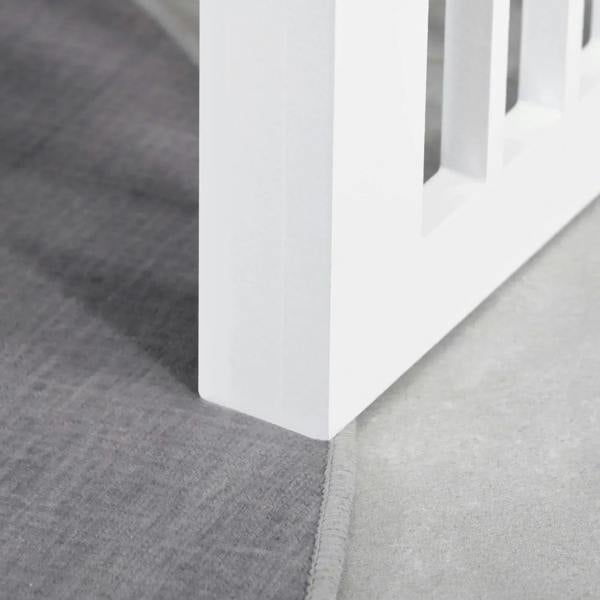White raised dog feeding stand base on gray floor with stainless bowls above