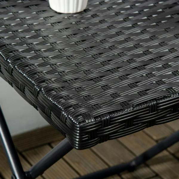 Close-up of black woven wicker corner edge on a square folding table