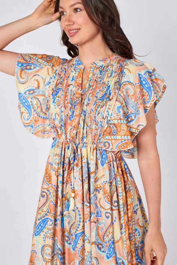 Woman wearing a colorful patterned dress on a white background