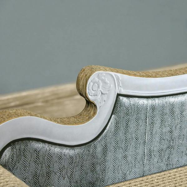 Close-up of brown cardboard cat lounger end with gray fabric trim and embossed emblem
