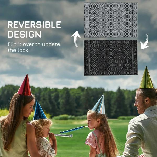 Black and grey reversible geometric outdoor rug, shown with two pattern sides