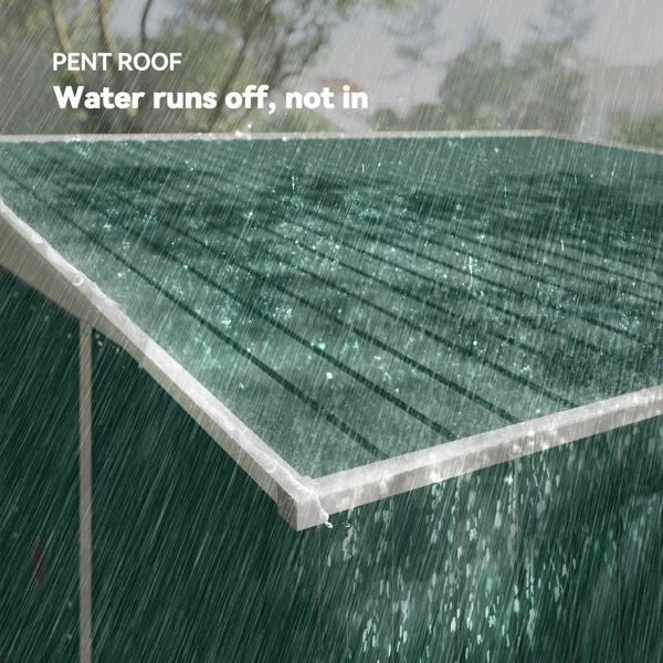 Green metal shed with pent roof and rainwater beading on the roof surface