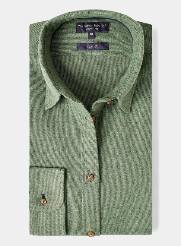 Green shirt with collar and buttons on a light gray background