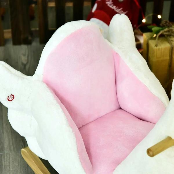 Pink padded seat cushion inside white plush swan rocking toy