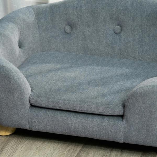 Grey pet sofa bed cushion close-up with tufted backrest and plush padded seat