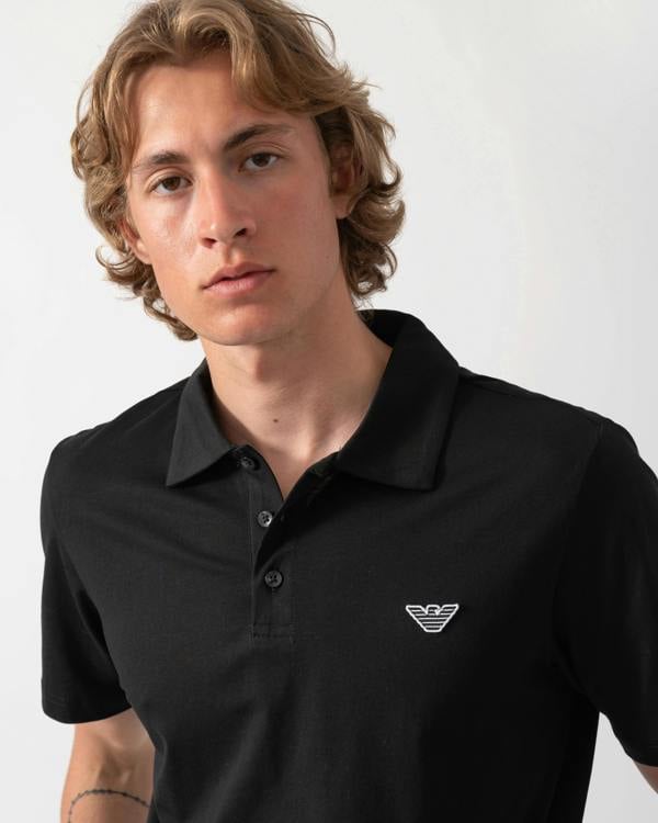 close up shot of a model wearing an Emporio Armani Mens Beach Polo with Eagle Logo in Black