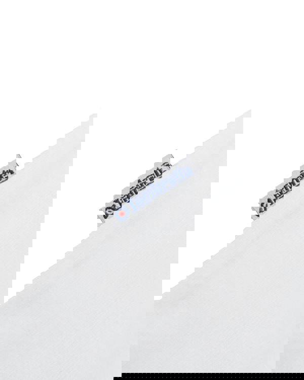 Lambretta Mens Multi Badges Mod Ska Casual T-Shirts, close-up view of the white fabric with Lambretta branding tag.