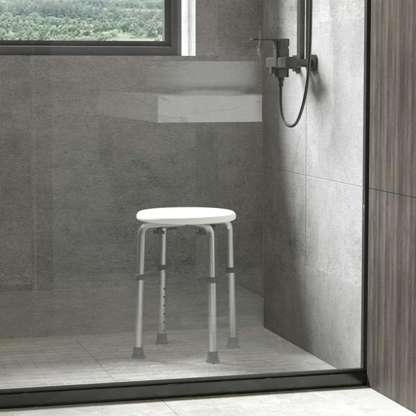 White shower stool with round seat and height-adjustable legs in shower area