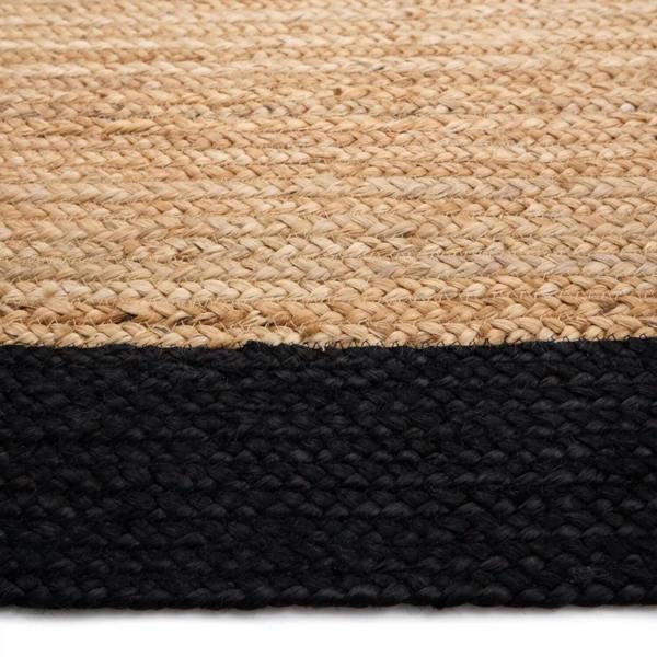 Close-up of a woven rug with a natural top layer and black bottom layer.