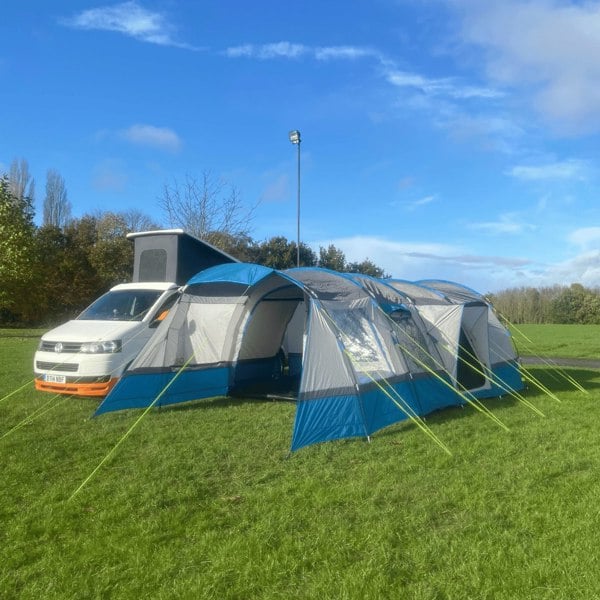 The Cocoon V2 Poled Campervan Awning on a quiet campsite attached to a VolksWagen T5