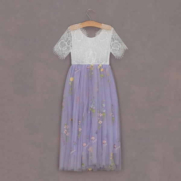 Lace top and floral skirt dress on a hanger against a gray background