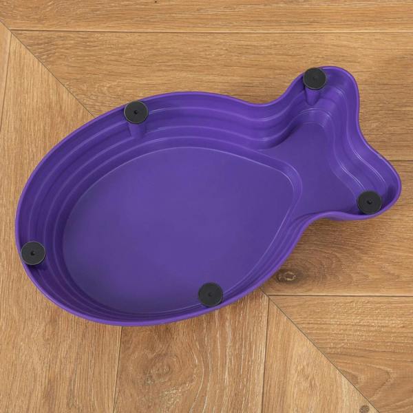 Purple kids stepping stone with ridged underside pads attached on a wooden surface